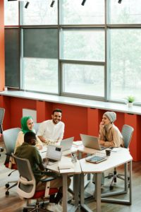 Four employees sitting at a table smiling and talking